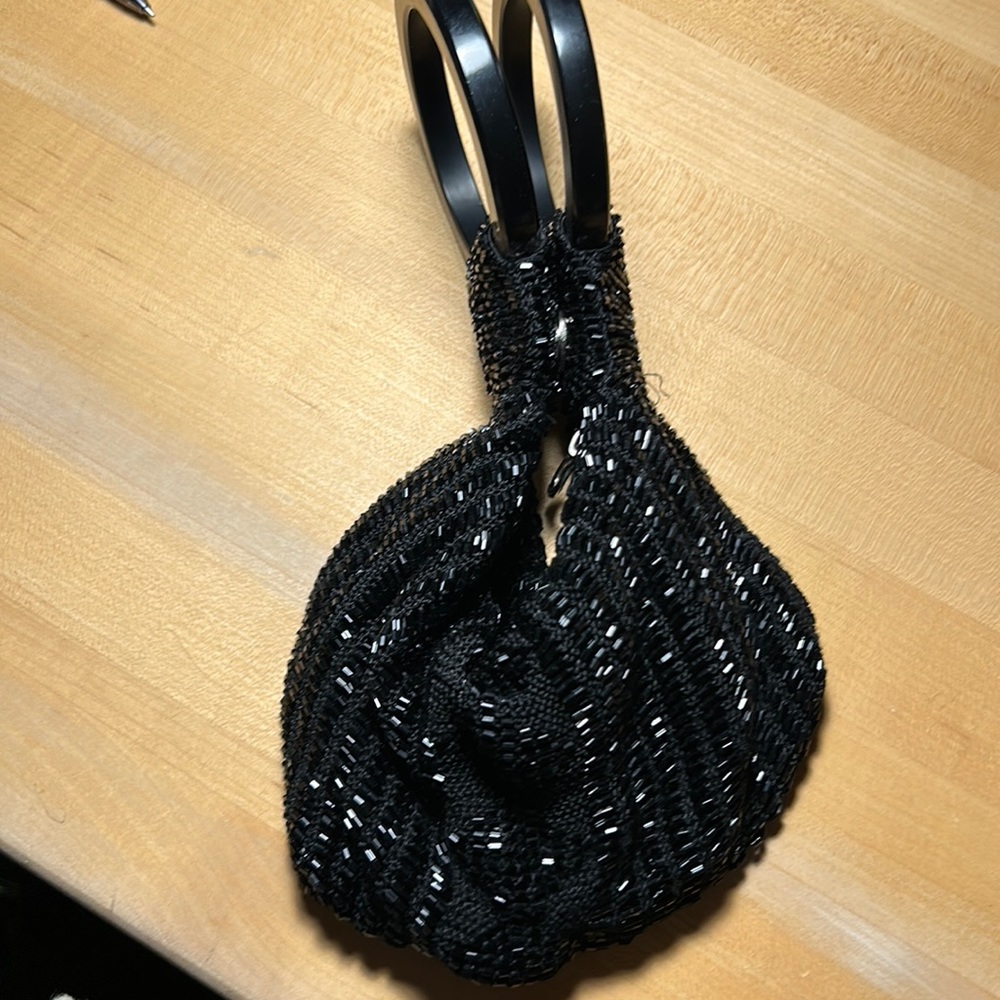 Black sequin evening bag with acrylic round handles very casual.